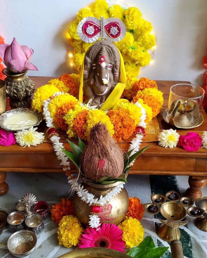 "Decorated idol of Lord Ganesha adorned with flowers and traditional offerings during Ganesh Chaturthi Puja, signifying the start of the festival celebrations."