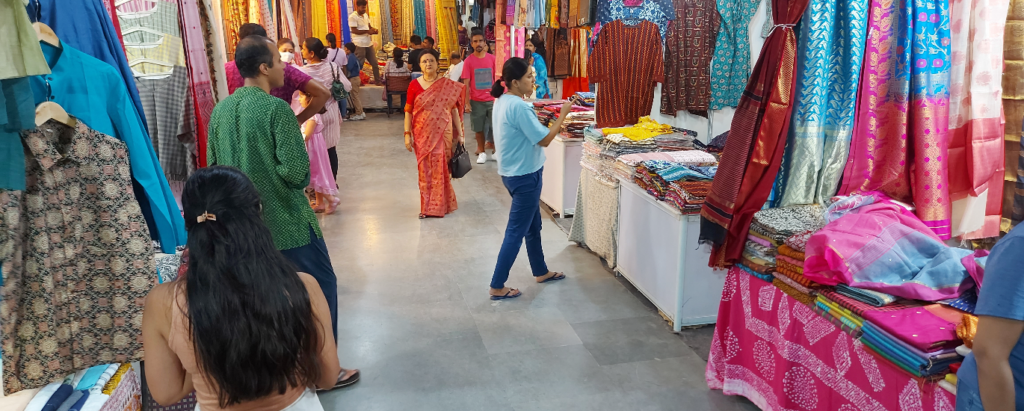 "Vibrant booths at National Handloom Fair 2024 showcasing colorful textiles and crafts from India and neighboring countries"