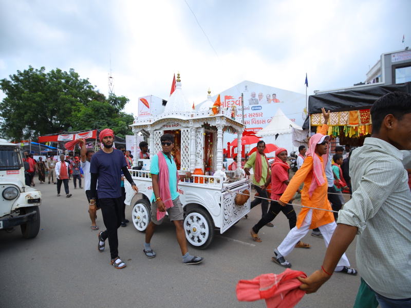 Colorful Bhadarvi Poonam Fair in Ambaji, Gujarat, with crowds of devotees, temple decorations, and cultural performances"
