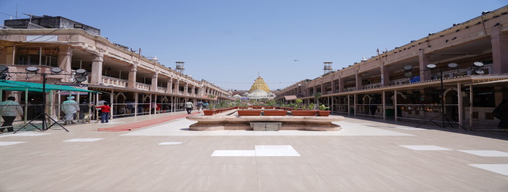 Colorful Bhadarvi Poonam Fair in Ambaji, Gujarat, with crowds of devotees, temple decorations, and cultural performances"