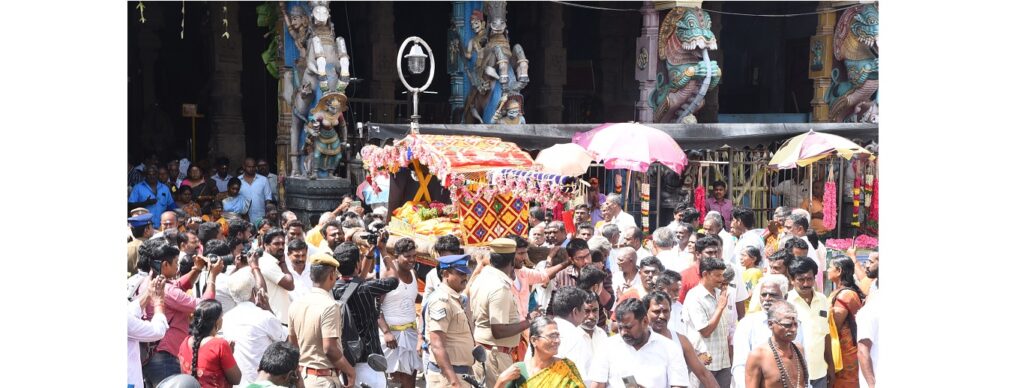 "Devotees offering colorful puttu dishes to Lord Shiva during the vibrant Puttu Festival in Madurai, with temple processions in the background"