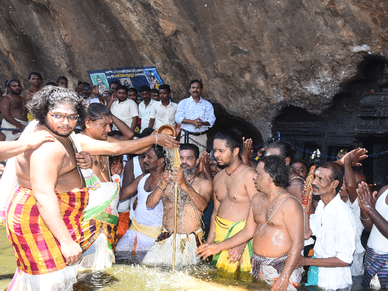 "Devotees offering colorful puttu dishes to Lord Shiva during the vibrant Puttu Festival in Madurai, with temple processions in the background"