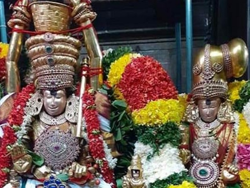 "Devotees offering colorful puttu dishes to Lord Shiva during the vibrant Puttu Festival in Madurai, with temple processions in the background"