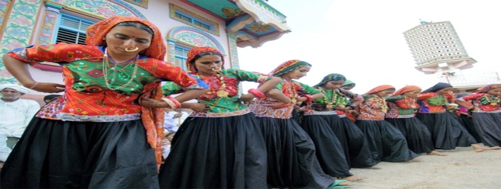 "Colorful Ravechi Fair in Gujarat with traditional buffalo cart races and devotees at the ancient Ravechi Temple"