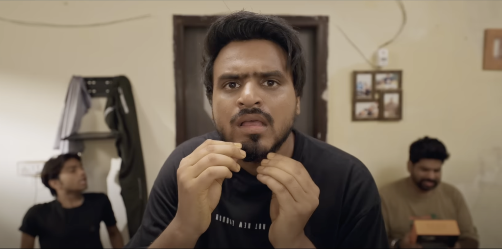 Amit Bhadana as Minku surrounded by his three girlfriends in a funny scene from the YouTube video "Girls Hostel."