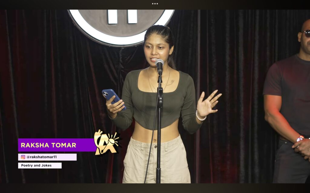 Indias Got Latent Episode 8 Raksha Tomar performing on stage, delivering a blend of humor and poetry. She engages the audience with witty lines that evoke laughter and deeper reflections, seamlessly transitioning between comedy and insightful poetry.