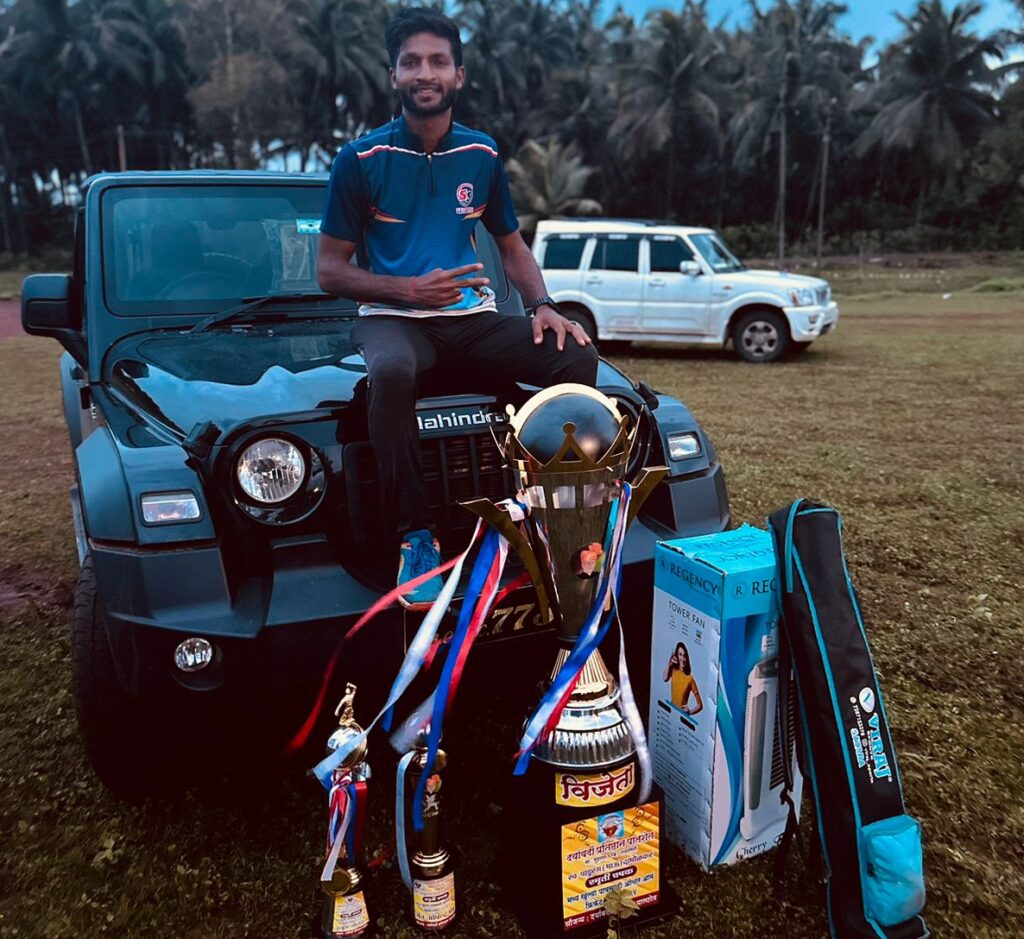 Mayur Manoj Kumbhar holding a trophy and celebrating his cricket achievements