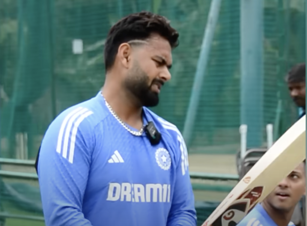 "Rishabh Pant in training with Ravichandran Ashwin, Axar Patel, and Yashasvi Jaiswal, practicing intense batting drills at a cricket field in Bengaluru."