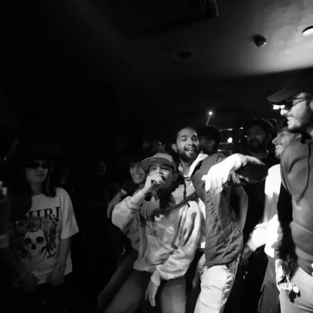"Lash Curry, Indian rapper and MTV Hustle 4 contestant, standing confidently backstage, wearing a stylish outfit and looking focused before his performance."