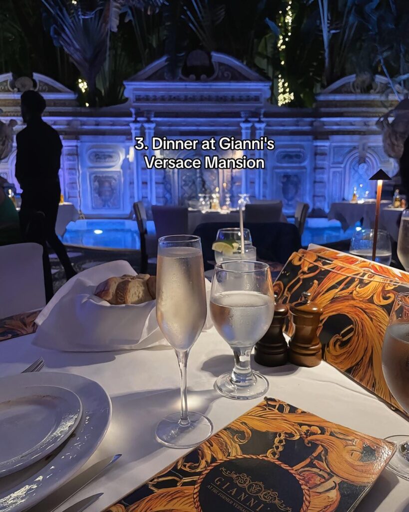 The luxurious interior of the Versace Mansion, showcasing ornate Baroque-style architecture and elegant dining tables.