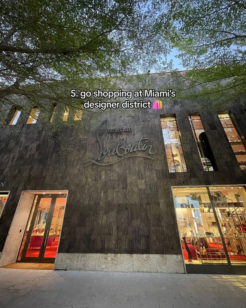 Modern architecture and luxury boutiques like Christian Louboutin in Miami’s Design District, surrounded by stylish shoppers.
