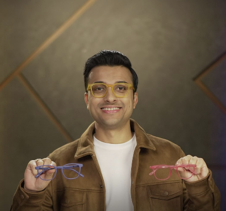 Featured Image: A vibrant, colorful design with Aashish Solanki smiling on stage, holding a microphone, with a spotlight on him. The background has a comedy club vibe with a crowd laughing. Bold text overlay reads: “Aashish Solanki: Comedy Star’s Net Worth & Family Secrets!” in a fun, yellow font. Include his YouTube logo and Shark Tank India logo in the corners for branding.
